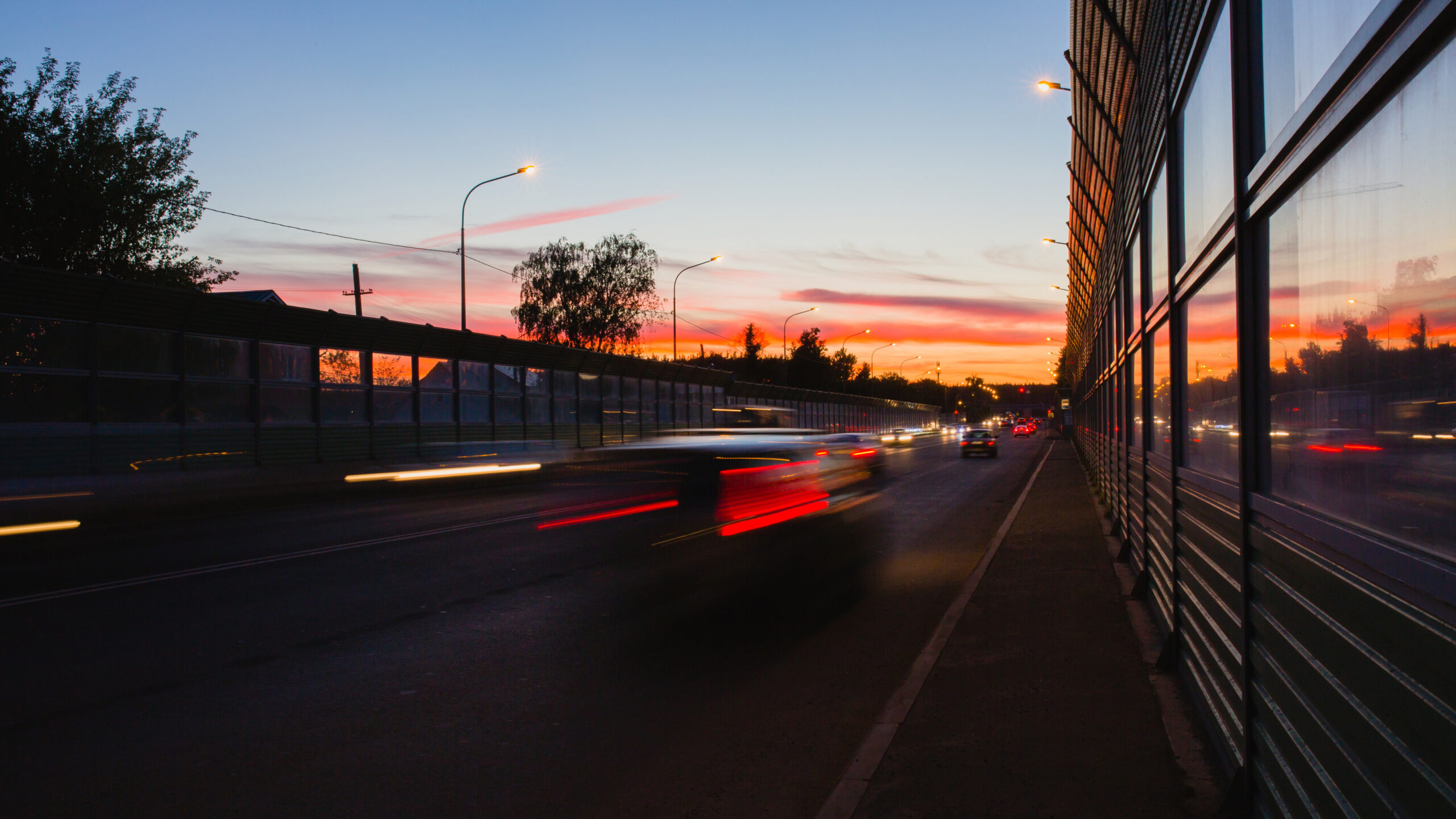 Summer landscape with highway and tracks from car headlights